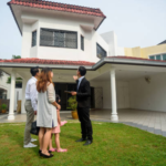 Real estate agent showing new home to clients stock photo